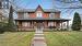 View of front of property with a porch and a front lawn