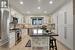 Kitchen featuring white cabinets, a kitchen island, and stainless steel appliances