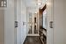 Primary bedroom walk-in closet with window and custom cabinetry