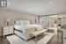 Bedroom with a barn door to ensuite and dark flooring