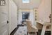 Home office with a textured ceiling, a skylight, and dark hardwood / wood-style floors