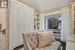 Home office with a textured ceiling, a skylight, and dark hardwood / wood-style floors