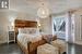 Bedroom featuring dark hardwood / wood-style floors and an inviting chandelier