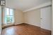 Unfurnished room with a baseboard heating unit, hardwood / wood-style floors, and a textured ceiling