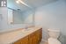 Bathroom with vanity, tile patterned floors, and toilet