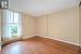 Empty room featuring a baseboard radiator, a textured ceiling, and light hardwood / wood-style floors