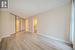 Unfurnished bedroom featuring light wood-type flooring and ensuite bath