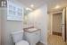 Full bathroom with vanity, shower / bath combination with curtain, and toilet