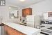 Kitchen featuring white refrigerator, kitchen peninsula, a textured ceiling, and electric stove