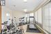 Exercise room with light tile patterned floors and a textured ceiling