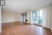 Empty room with a baseboard heating unit, hardwood / wood-style flooring, and a textured ceiling