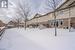 View of snow covered back of property