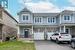 View of front of home featuring a garage and a front lawn