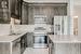 Kitchen featuring sink, light tile patterned floors, stainless steel appliances, tasteful backsplash, and light stone countertops