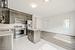 Kitchen featuring light tile patterned floors, dark brown cabinets, stainless steel appliances, a kitchen island, and decorative backsplash