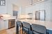 Kitchen with stainless steel appliances, a kitchen island, light hardwood flooring, white cabinetry, and sink