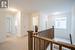 Hallway featuring washer / clothes dryer and light colored carpet