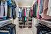 Walk in closet featuring custom cabinets/shelving