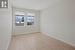 Spare room featuring light wood-type flooring, a textured ceiling, and baseboards