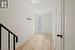 Foyer with stairs, light wood-type flooring, and baseboards