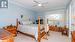 Carpeted bedroom featuring ornamental molding and ceiling fan