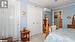 Bedroom featuring a closet, light carpet, a wall mounted AC, and crown molding