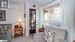 Living area featuring a wall unit AC, light colored carpet, and crown molding