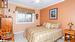 Bedroom featuring ornamental molding, carpet flooring, and ceiling fan