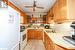 Kitchen with sink, ceiling fan, light tile patterned floors, backsplash, and white appliances