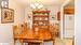 Dining space with light tile patterned floors, an inviting chandelier, and ornamental molding