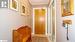 Hall with light tile patterned floors and crown molding