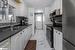 Kitchen featuring stainless steel appliances, white cabinetry, sink, and tasteful backsplash