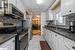 Kitchen featuring white cabinets, stainless steel appliances, and tasteful backsplash