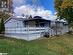 Rear view of property with a lawn and a deck