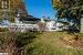 Back of property with a lawn and a gazebo