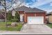 Single story home featuring a garage and a front lawn