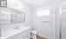 Bathroom with toilet, a shower, vanity, and hardwood / wood-style floors