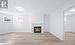 Unfurnished living room with a fireplace and light wood-type flooring