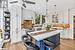 Kitchen with white cabinets, a kitchen breakfast bar, and a kitchen island