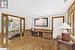 Bedroom featuring rail lighting and hardwood / wood-style flooring