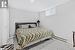 Carpeted bedroom featuring a closet and a baseboard radiator