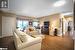 Living room with hardwood / wood-style floors and cornice molding