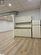 Kitchen featuring a paneled ceiling, light hardwood / wood-style floors, sink, cream cabinetry, and white fridge