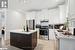 Kitchen with a center island, stainless steel appliances, and white cabinetry