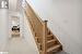 Staircase with carpet and lofted ceiling