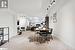 Dining space with light colored carpet and rail lighting