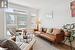 Living room with a wealth of natural light and light hardwood / wood-style floors