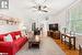 Living room with hardwood / wood-style flooring and ceiling fan