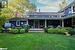 Rear view of property featuring a lawn and a deck