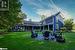 Back of house with a fire pit, a yard, and a patio area